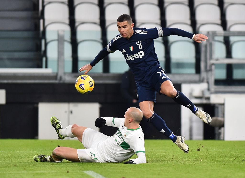 Soccer Football - Serie A - Juventus v U.S. Sassuolo - Allianz Stadium, Turin, Italy - January 10, 2021 Sassuolo's Vlad Chiriches in action with Juventus' Cristiano Ronaldo REUTERS/Massimo Pinca