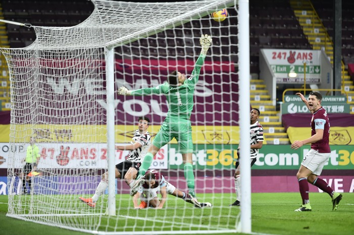 Manchester Uniteds Harry Maguire, left, scores a goal that was later disallowed during the English Premier League soccer match between Burnley and Manchester United in Burnley, England, Tuesday, Jan. 12, 2021. (Peter Powell/Pool via AP)