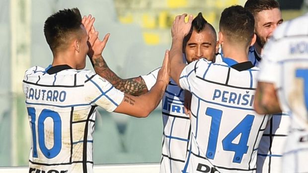 Inter's Vidal, center, celebrates with teammates after scoring his side's first goal on a penalty kick during the Italian Cup round of 16 soccer match between Fiorentina and Inter Milan, at the Artemio Franchi stadium in Florence, Italy, Wednesday, Jan. 13, 2021. (Jennifer Lorenzini/LaPresse via AP)