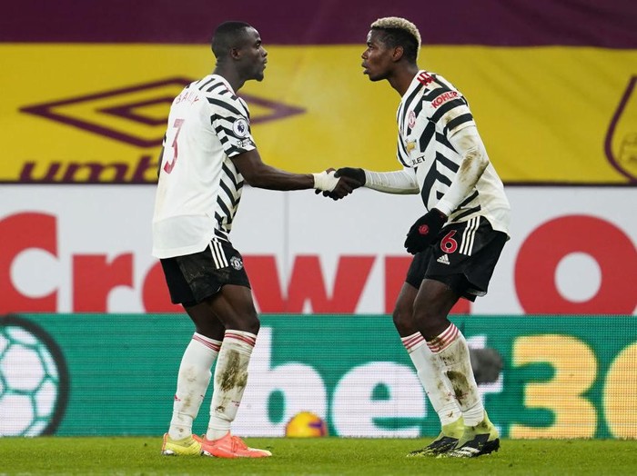 BURNLEY, ENGLAND - JANUARY 12: Paul Pogba of Manchester United celebrates with Eric Bailly after scoring their teams first goal during the Premier League match between Burnley and Manchester United at Turf Moor on January 12, 2021 in Burnley, England. Sporting stadiums around England remain under strict restrictions due to the Coronavirus Pandemic as Government social distancing laws prohibit fans inside venues resulting in games being played behind closed doors. (Photo by Jon Super - Pool/Getty Images)