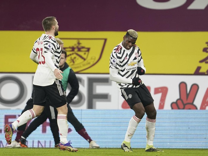 Manchester Uniteds Paul Pogba, right, dances as he celebrates after scoring during the English Premier League soccer match between Burnley and Manchester United in Burnley, England, Tuesday, Jan. 12, 2021. Manchester won the match 1-0.(AP Photo/Jon Super,Pool)