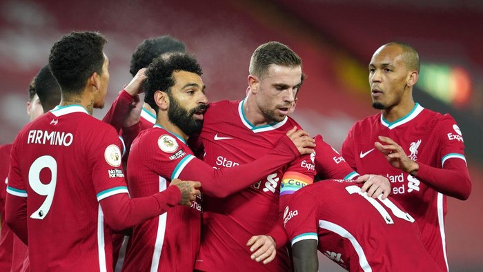 LIVERPOOL, ENGLAND - DECEMBER 06: Mohamed Salah (2L) of Liverpool celebrates with team mates Jordan Henderson (2R), Roberto Firminho (L) and Fabinho (R) after scoring their sides first goal during the Premier League match between Liverpool and Wolverhampton Wanderers at Anfield on December 06, 2020 in Liverpool, England. A limited number of fans (2000) are welcomed back to stadiums to watch elite football across England. This was following easing of restrictions on spectators in tiers one and two areas only. (Photo by Jon Super - Pool/Getty Images)
