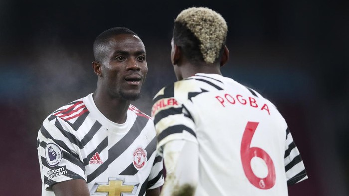 BURNLEY, ENGLAND - JANUARY 12: Paul Pogba of Manchester United celebrates with Eric Bailly after scoring their teams first goal during the Premier League match between Burnley and Manchester United at Turf Moor on January 12, 2021 in Burnley, England. Sporting stadiums around England remain under strict restrictions due to the Coronavirus Pandemic as Government social distancing laws prohibit fans inside venues resulting in games being played behind closed doors. (Photo by Clive Brunskill/Getty Images)