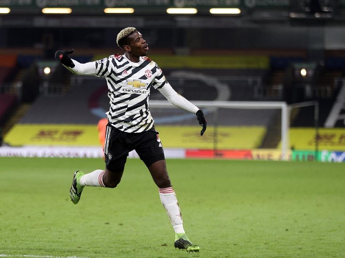 BURNLEY, ENGLAND - JANUARY 12: Paul Pogba of Manchester United celebrates after scoring their teams first goal during the Premier League match between Burnley and Manchester United at Turf Moor on January 12, 2021 in Burnley, England. Sporting stadiums around England remain under strict restrictions due to the Coronavirus Pandemic as Government social distancing laws prohibit fans inside venues resulting in games being played behind closed doors. (Photo by Clive Brunskill/Getty Images)