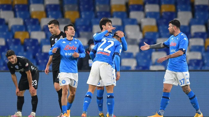 NAPLES, ITALY - JANUARY 13: Giovanni Di Lorenzo of S.S.C. Napoli  celebrates with teammates Hirving Lozano, Eljif Elmas and Andrea Petagna after scoring their teams first goal during the Coppa Italia match between SSC Napoli and Empoli FC at Stadio Diego Armando Maradona on January 13, 2021 in Naples, Italy. Sporting stadiums around Italy remain under strict restrictions due to the Coronavirus Pandemic as Government social distancing laws prohibit fans inside venues resulting in games being played behind closed doors. (Photo by Francesco Pecoraro/Getty Images)