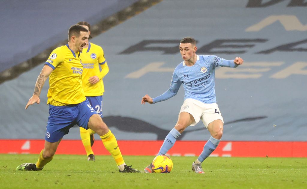 MANCHESTER, ENGLAND - JANUARY 13: Phil Foden of Manchester City makes a break during the Premier League match between Manchester City and Brighton & Hove Albion at Etihad Stadium on January 13, 2021 in Manchester, England. Sporting stadiums around England remain under strict restrictions due to the Coronavirus Pandemic as Government social distancing laws prohibit fans inside venues resulting in games being played behind closed doors. (Photo by Clive Brunskill/Getty Images)