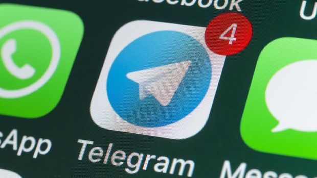 London, UK - July 30, 2022: The buttons of Telegram, WhatsApp, Facebook, Messages and other apps on the screen of an iPhone.