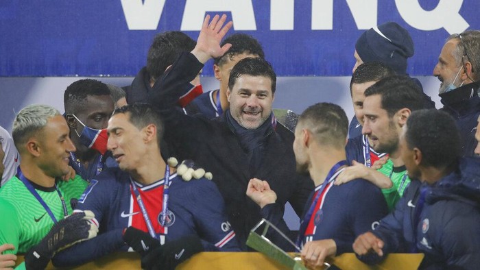 PSGs head coach Mauricio Pochettino, center, and PSG players celebrate with the trophy after the Champions Trophy soccer match between Paris Saint-Germain and Olympique Marseille at the Bollaert stadium in Lens, northern France, Wednesday, Jan.13, 2021. PSG won 2:1. (AP Photo/Christophe Ena)