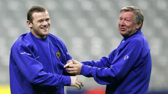 FILE - In this Tuesday, Nov. 1, 2005 file photo Wayne Rooney of Manchester United, left, jokes with his coach Alex Ferguson during a training session at the Stade de France stadium, outside Paris. Lille will face Manchester United Wednesday in a European Champions League match. Wayne Rooney now has the Derby County job on a permanent basis after England’s record goal-scorer retired from playing and received a contract through 2023 to manage the second tier team. The 35-year-old former Manchester United captain, who took temporary charge of Derby in November, is now focusing on his coaching career.  (AP Photo/Christophe Ena, File)