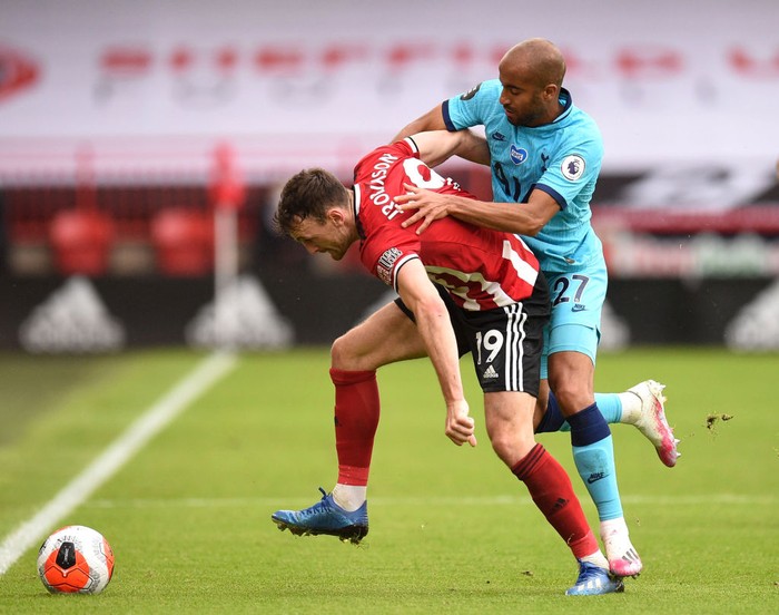 SHEFFIELD, ENGLAND - JULY 02: Jack Robinson of Sheffield United is challenged by Lucas Moura of Tottenham Hotspur during the Premier League match between Sheffield United and Tottenham Hotspur at Bramall Lane on July 02, 2020 in Sheffield, England. Football Stadiums around Europe remain empty due to the Coronavirus Pandemic as Government social distancing laws prohibit fans inside venues resulting in all fixtures being played behind closed doors. (Photo by Oli Scarff/Pool via Getty Images)