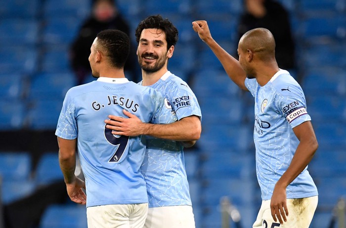 MANCHESTER, ENGLAND - JANUARY 17: Ilkay Gundogan of Manchester City celebrates with team mates (L - R) Gabriel Jesus and Fernandinho after scoring their sides second goal during the Premier League match between Manchester City and Crystal Palace at Etihad Stadium on January 17, 2021 in Manchester, England. Sporting stadiums around England remain under strict restrictions due to the Coronavirus Pandemic as Government social distancing laws prohibit fans inside venues resulting in games being played behind closed doors. (Photo by Peter Powell - Pool/Getty Images)