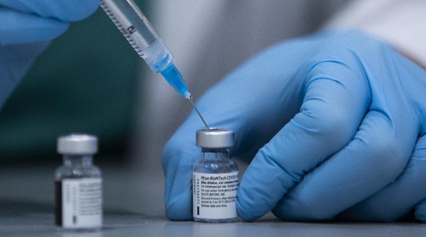 A health care professional prepares a Pfizer-BioNTech COVID-19 vaccine at Sheba Tel Hashomer Hospital in Ramat Gan, Israel, Tuesday, Jan. 12, 2021. Israel has struck a deal with Pfizer, promising to share vast troves of medical data with the drugmaker in exchange for the continued flow of its COVID-19 vaccine. Critics say the deal is raising major ethical concerns, including possible privacy violations and a deepening of the global divide between wealthy countries and poorer populations, including Palestinians in the occupied West Bank and Gaza, who face long waits to be inoculated. (AP Photo/Oded Balilty)