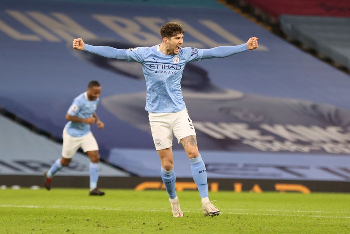 MANCHESTER, ENGLAND - JANUARY 17: John Stones of Manchester City  celebrates after scoring their sides third goal during the Premier League match between Manchester City and Crystal Palace at Etihad Stadium on January 17, 2021 in Manchester, England. Sporting stadiums around England remain under strict restrictions due to the Coronavirus Pandemic as Government social distancing laws prohibit fans inside venues resulting in games being played behind closed doors. (Photo by Clive Brunskill/Getty Images)
