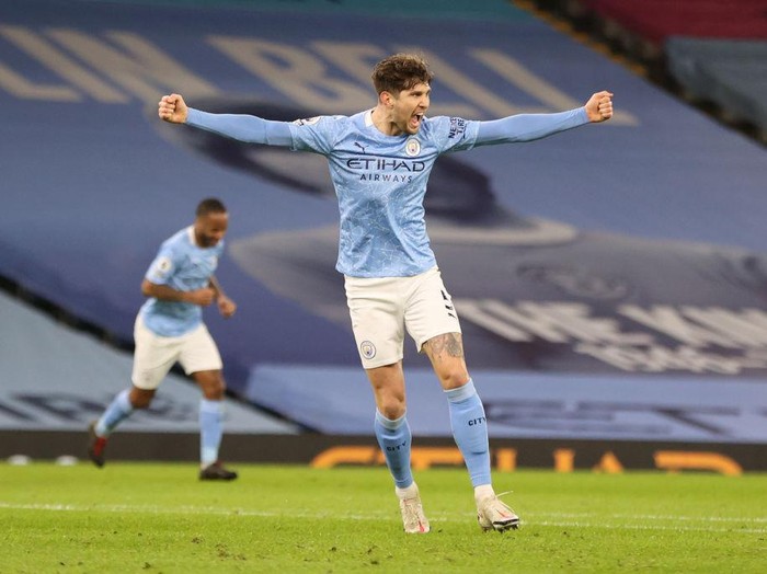 MANCHESTER, ENGLAND - JANUARY 17: John Stones of Manchester City  celebrates after scoring their sides third goal during the Premier League match between Manchester City and Crystal Palace at Etihad Stadium on January 17, 2021 in Manchester, England. Sporting stadiums around England remain under strict restrictions due to the Coronavirus Pandemic as Government social distancing laws prohibit fans inside venues resulting in games being played behind closed doors. (Photo by Clive Brunskill/Getty Images)