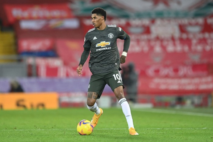 LIVERPOOL, ENGLAND - JANUARY 17: Marcus Rashford of Manchester United runs with the ball during the Premier League match between Liverpool and Manchester United at Anfield on January 17, 2021 in Liverpool, England. Sporting stadiums around England remain under strict restrictions due to the Coronavirus Pandemic as Government social distancing laws prohibit fans inside venues resulting in games being played behind closed doors. (Photo by Michael Regan/Getty Images)