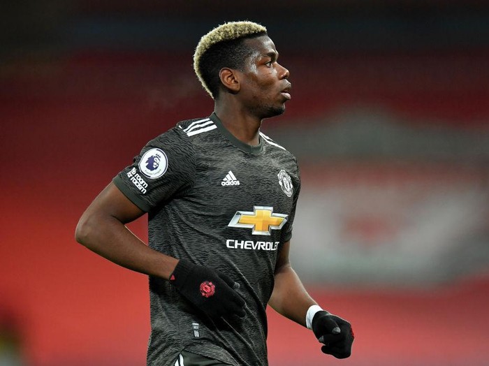 LIVERPOOL, ENGLAND - JANUARY 17: Paul Pogba of Manchester United in running action during the Premier League match between Liverpool and Manchester United at Anfield on January 17, 2021 in Liverpool, England. Sporting stadiums around England remain under strict restrictions due to the Coronavirus Pandemic as Government social distancing laws prohibit fans inside venues resulting in games being played behind closed doors. (Photo by Paul Ellis - Pool/Getty Images)