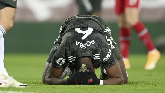 Manchester Uniteds Paul Pogba reacts after failing to score during the English Premier League soccer match between Liverpool and Manchester United at Anfield Stadium, Liverpool, England, Sunday, Jan. 17, 2021. (Michael Regan/Pool via AP)