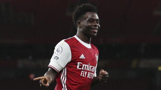 Soccer Football - Premier League - Arsenal v Newcastle United - Emirates Stadium, London, Britain - January 18, 2021 Arsenal's Bukayo Saka celebrates scoring their second goal Pool via REUTERS/Catherine Ivill EDITORIAL USE ONLY. No use with unauthorized audio, video, data, fixture lists, club/league logos or 'live' services. Online in-match use limited to 75 images, no video emulation. No use in betting, games or single club /league/player publications.  Please contact your account representative for further details.