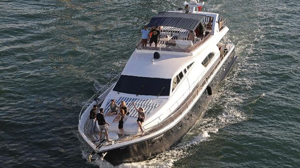 Tourists party on a yacht in Dubai, United Arab Emirates, Tuesday, Jan. 12, 2021. Since becoming one of the world's first destinations to open up for tourism, Dubai has promoted itself as the ideal pandemic vacation spot. With peak tourism season in full swing, coronavirus infections are surging to unprecedented heights, with daily case counts nearly tripling in the past month, but in the face of a growing economic crisis, the city won't lock down and can't afford to stand still. (AP Photo/Kamran Jebreili)