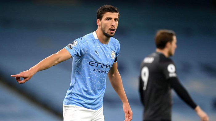 MANCHESTER, ENGLAND - JANUARY 06: John Stones of Manchester City celebrates at the final whistle with Ruben Dias of Manchester City during the Carabao Cup Semi Final match between Manchester United and Manchester City at Old Trafford on January 06, 2021 in Manchester, England. The match will be played without fans, behind closed doors as a Covid-19 precaution. (Photo by Peter Powell - Pool/Getty Images)
