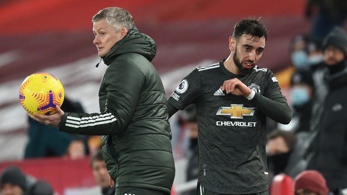 LIVERPOOL, ENGLAND - JANUARY 17: Ole Gunnar Solskjaer, Manager of Manchester United interacts with Bruno Fernandes of Manchester United after being substituted during the Premier League match between Liverpool and Manchester United at Anfield on January 17, 2021 in Liverpool, England. Sporting stadiums around England remain under strict restrictions due to the Coronavirus Pandemic as Government social distancing laws prohibit fans inside venues resulting in games being played behind closed doors. (Photo by Michael Regan/Getty Images)