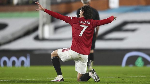 Manchester United's Edinson Cavani celebrates after scoring his side's opening goal during the English Premier League soccer match between Fulham and Manchester United at the Craven Cottage stadium in London, Wednesday, Jan. 20, 2021. (Clive Rose/Pool via AP)