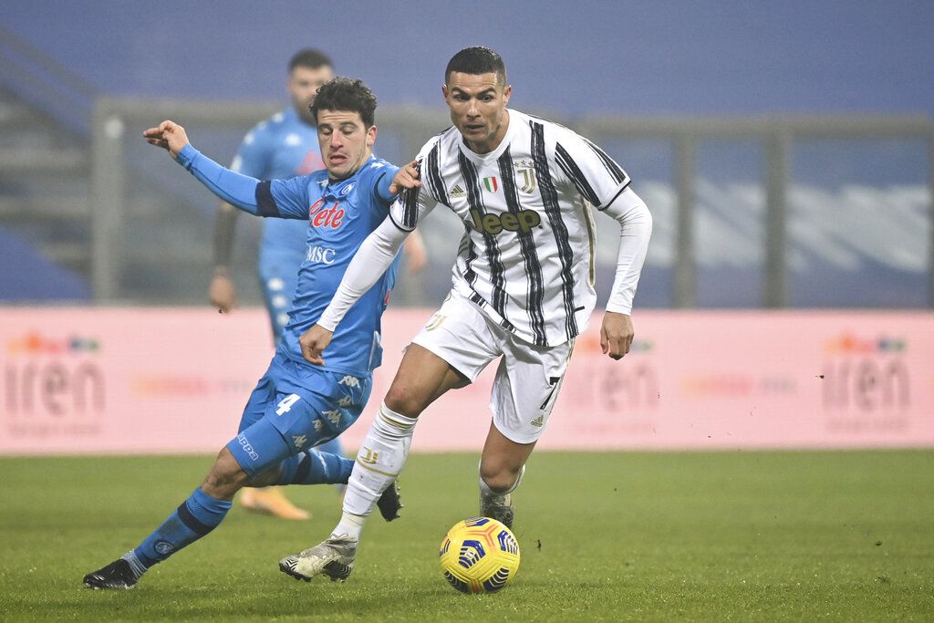 Juventus' Cristiano Ronaldo runs to celebrate after scoring his team's opening goal during the Italian Super Cup final soccer match between Juventus and Napoli at the Mapei stadium in Reggio Emilia, Italy, Wednesday, Jan. 20, 2021. (AP Photo/Antonio Calanni)