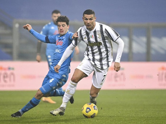 Juventus' Cristiano Ronaldo runs to celebrate after scoring his team's opening goal during the Italian Super Cup final soccer match between Juventus and Napoli at the Mapei stadium in Reggio Emilia, Italy, Wednesday, Jan. 20, 2021. (AP Photo/Antonio Calanni)