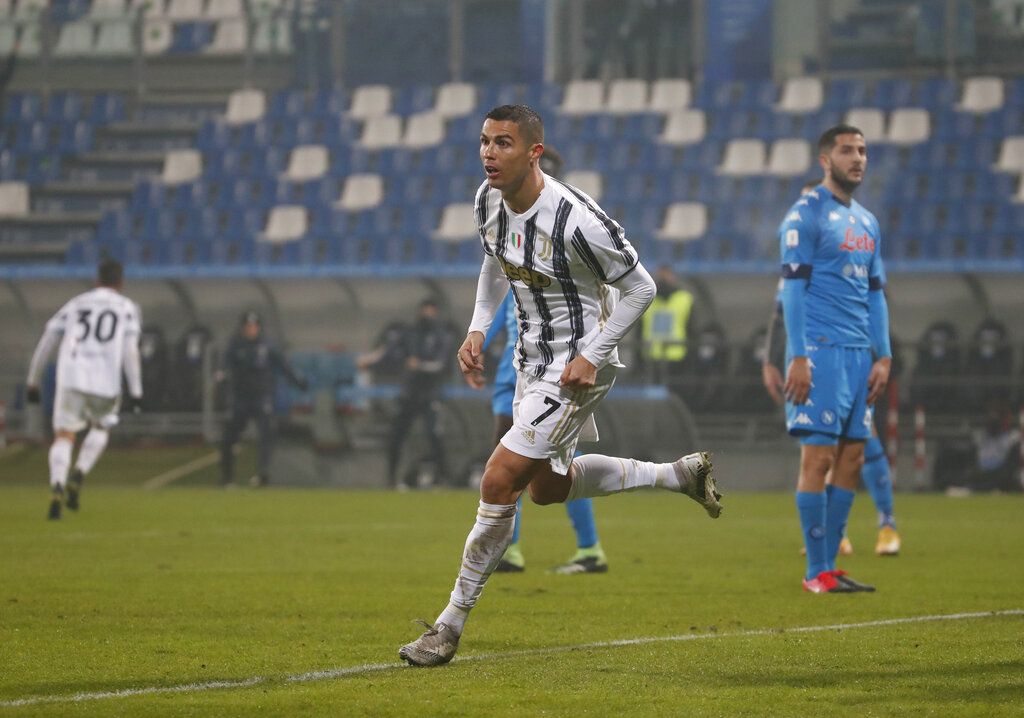 Juventus' Cristiano Ronaldo runs to celebrate after scoring his team's opening goal during the Italian Super Cup final soccer match between Juventus and Napoli at the Mapei stadium in Reggio Emilia, Italy, Wednesday, Jan. 20, 2021. (AP Photo/Antonio Calanni)