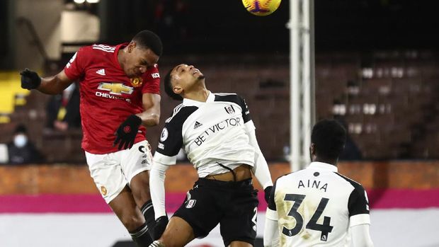 Manchester United's Anthony Martial, left, heads the ball during the English Premier League soccer match between Fulham and Manchester United at the Craven Cottage stadium in London, Wednesday, Jan. 20, 2021. (Clive Rose/Pool via AP)