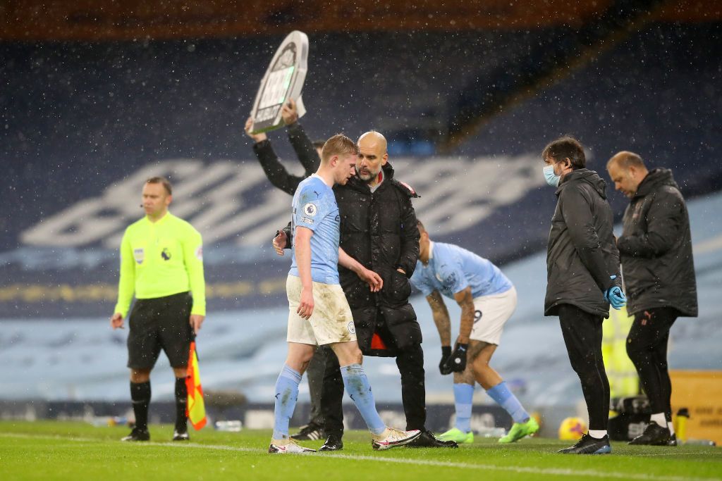 MANCHESTER, ENGLAND - JANUARY 20: Pep Guardiola, Manager of Manchester City greets Kevin De Bruyne of Manchester City off the pitch after he is substituted during the Premier League match between Manchester City and Aston Villa at Etihad Stadium on January 20, 2021 in Manchester, England. Sporting stadiums around the UK remain under strict restrictions due to the Coronavirus Pandemic as Government social distancing laws prohibit fans inside venues resulting in games being played behind closed doors. (Photo by Martin Rickett - Pool/Getty Images)