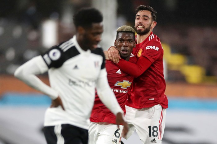 LONDON, ENGLAND - JANUARY 20: Paul Pogba of Manchester United celebrates with team mate Bruno Fernandes of Manchester United after scoring their sides second goal during the Premier League match between Fulham and Manchester United at Craven Cottage on January 20, 2021 in London, England. Sporting stadiums around the UK remain under strict restrictions due to the Coronavirus Pandemic as Government social distancing laws prohibit fans inside venues resulting in games being played behind closed doors. (Photo by Peter Cziborra - Pool/Getty Images)