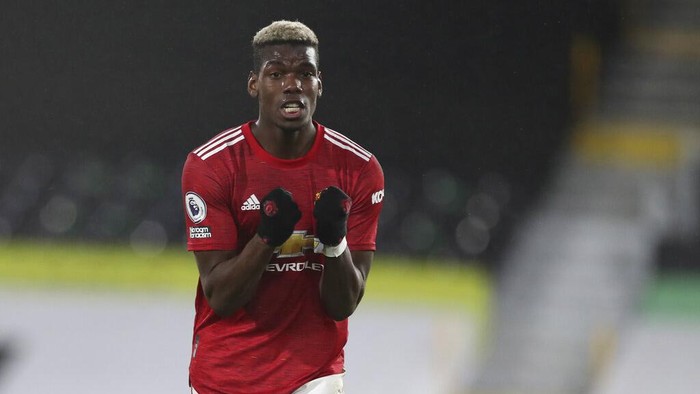 Manchester Uniteds Paul Pogba celebrates at the end of the English Premier League soccer match between Fulham and Manchester United at the Craven Cottage stadium in London, Wednesday, Jan. 20, 2021. (Peter Cziborra/Pool via AP)
