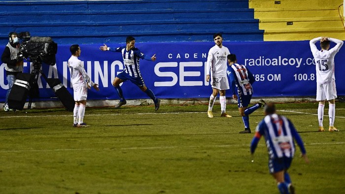 Alcoyanos Juanan, 2nd left, celebrates after scoring his sides second goal to knock out Real Madrid during a Spanish Copa del Rey round of 32 soccer match between Alcoyano and Real Madrid at the El Collao stadium in Alcoy, Spain, Wednesday Jan. 20, 2021. (AP Photo/Jose Breton)