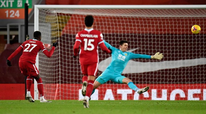 LIVERPOOL, ENGLAND - JANUARY 21: Divock Origi of Liverpool shoots past Nick Pope of Burnley and hits the crossbar during the Premier League match between Liverpool and Burnley at Anfield on January 21, 2021 in Liverpool, England. Sporting stadiums around the UK remain under strict restrictions due to the Coronavirus Pandemic as Government social distancing laws prohibit fans inside venues resulting in games being played behind closed doors. (Photo by Peter Powell - Pool/Getty Images)