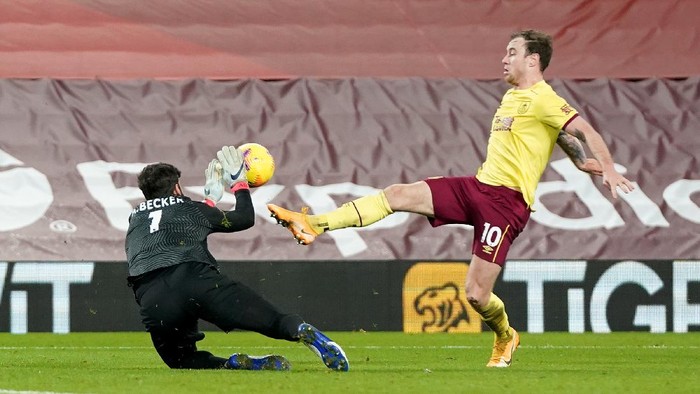 LIVERPOOL, ENGLAND - JANUARY 21: Ashley Barnes of Burnley is fouled by Alisson Becker of Liverpool leading to a penalty being awarded during the Premier League match between Liverpool and Burnley at Anfield on January 21, 2021 in Liverpool, England. Sporting stadiums around the UK remain under strict restrictions due to the Coronavirus Pandemic as Government social distancing laws prohibit fans inside venues resulting in games being played behind closed doors. (Photo by Jon Super - Pool/Getty Images)