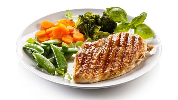 Grilled chicken breast with vegetable salad on white background