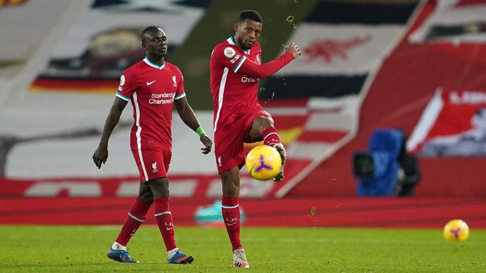 LIVERPOOL, ENGLAND - JANUARY 21: Georginio Wijnaldum of Liverpool reacts as he walks off the pitch with team mate Sadio Mane of Liverpool following the Premier League match between Liverpool and Burnley at Anfield on January 21, 2021 in Liverpool, England. Sporting stadiums around the UK remain under strict restrictions due to the Coronavirus Pandemic as Government social distancing laws prohibit fans inside venues resulting in games being played behind closed doors. (Photo by Jon Super - Pool/Getty Images)