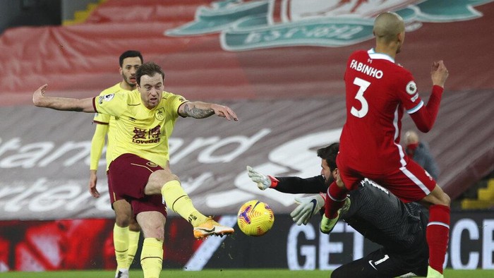 Liverpools goalkeeper Alisson saves a shot by Burnleys Ashley Barnes, left, during the English Premier League soccer match between Liverpool and Burnley in Liverpool, England, Thursday, Jan. 21, 2021. (Clive Brunskill//Pool via AP)