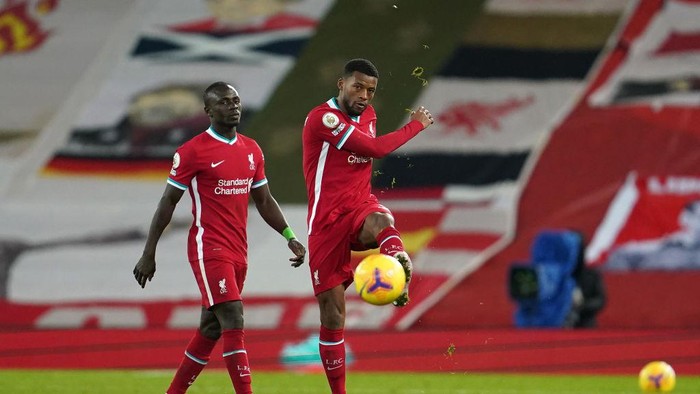 LIVERPOOL, ENGLAND - JANUARY 21: Georginio Wijnaldum of Liverpool reacts as he walks off the pitch with team mate Sadio Mane of Liverpool following the Premier League match between Liverpool and Burnley at Anfield on January 21, 2021 in Liverpool, England. Sporting stadiums around the UK remain under strict restrictions due to the Coronavirus Pandemic as Government social distancing laws prohibit fans inside venues resulting in games being played behind closed doors. (Photo by Jon Super - Pool/Getty Images)