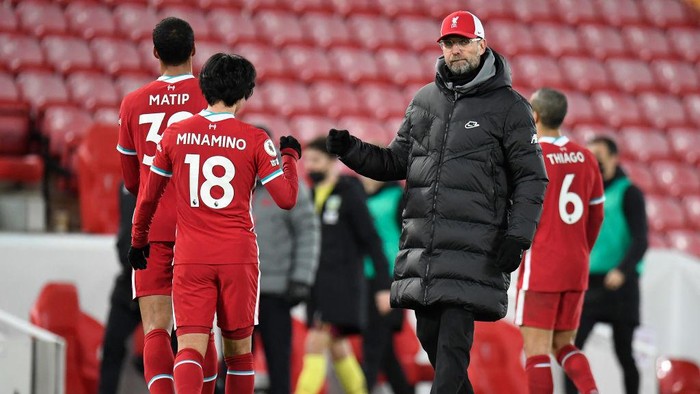 LIVERPOOL, ENGLAND - JANUARY 21: Jurgen Klopp, Manager of Liverpool interacts with Takumi Minamino of Liverpool following the Premier League match between Liverpool and Burnley at Anfield on January 21, 2021 in Liverpool, England. Sporting stadiums around the UK remain under strict restrictions due to the Coronavirus Pandemic as Government social distancing laws prohibit fans inside venues resulting in games being played behind closed doors. (Photo by Peter Powell - Pool/Getty Images)