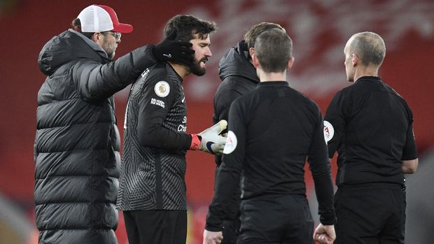 Soccer Football - Premier League - Liverpool v Burnley - Anfield, Liverpool, Britain - January 21, 2021 Liverpool's Alisson looks dejected with manager Juergen Klopp as he remonstrates with referee Mike Dean after the match Pool via REUTERS/Peter Powell EDITORIAL USE ONLY. No use with unauthorized audio, video, data, fixture lists, club/league logos or 'live' services. Online in-match use limited to 75 images, no video emulation. No use in betting, games or single club /league/player publications.  Please contact your account representative for further details.
