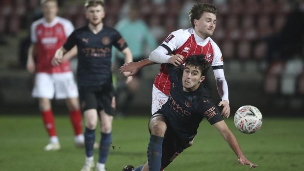 Cheltenham Town's Alfie May, collides with Manchester City's Eric Garcia who falls during the English FA Cup fourth round soccer match between Cheltenham Town and Manchester City at the Jonny-Rocks stadium in Cheltenham, England Saturday, Jan. 23, 2021. (Nick Potts /Pool via AP)