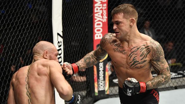 Jan 23, 2021; Abu Dhabi, United Arab Emirates; Dustin Poirier punches Conor McGregor of Ireland in a lightweight fight during the UFC 257 event inside Etihad Arena on UFC Fight Island.  Mandatory Credit: Jeff Bottari/Handout Photo via USA TODAY Sports