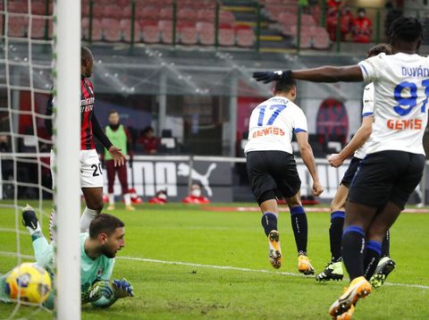 Atalanta's Cristian Romero, center, celebrates after scoring his side's opening goal during the Serie A soccer match between AC Milan and Atalanta at the Milan San Siro Stadium, Italy, Saturday, Jan. 23, 2021. (AP Photo/Antonio Calanni)