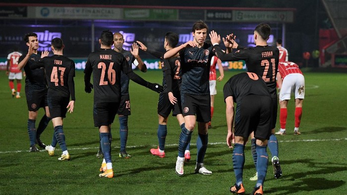 CHELTENHAM, ENGLAND - JANUARY 23: Ferran Torres of Manchester City celebrates with team mate Ruben Dias after scoring their sides third goal during The Emirates FA Cup Fourth Round match between Cheltenham Town and Manchester City at Jonny Rocks Stadium on January 23, 2021 in Cheltenham, England. Sporting stadiums around the UK remain under strict restrictions due to the Coronavirus Pandemic as Government social distancing laws prohibit fans inside venues resulting in games being played behind closed doors. (Photo by Shaun Botterill/Getty Images)