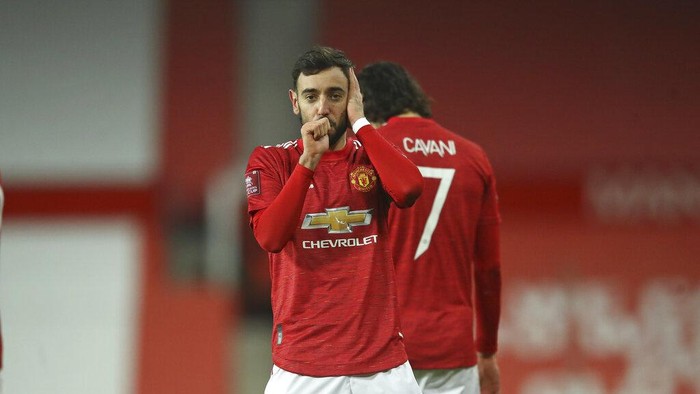Manchester Uniteds Bruno Fernandes celebrates after scoring his sides third goal during the English FA Cup 4th round soccer match between Manchester United and Liverpool at Old Trafford in Manchester, England, Sunday, Jan. 24, 2021. (Martin Rickett/Pool via AP)