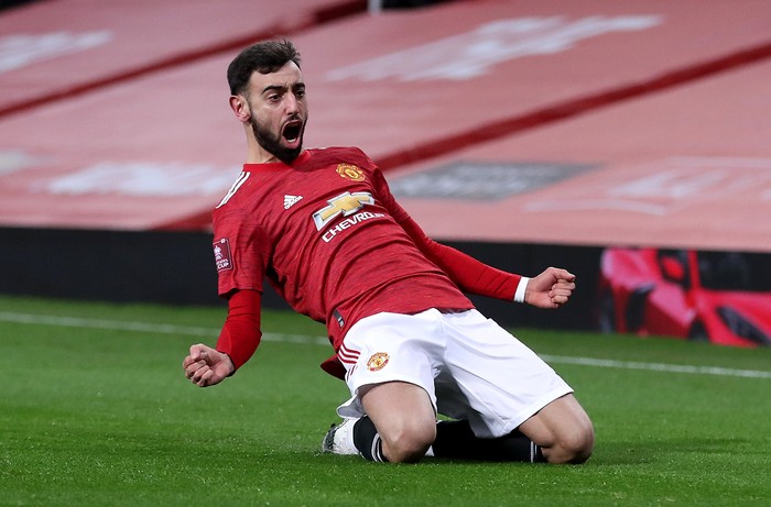 MANCHESTER, ENGLAND - JANUARY 24: Bruno Fernandes of Manchester United celebrates after scoring their sides third goal from a free kick during The Emirates FA Cup Fourth Round match between Manchester United and Liverpool at Old Trafford on January 24, 2021 in Manchester, England. Sporting stadiums around the UK remain under strict restrictions due to the Coronavirus Pandemic as Government social distancing laws prohibit fans inside venues resulting in games being played behind closed doors. (Photo by Martin Rickett - Pool/Getty Images)