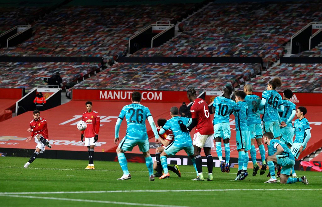 MANCHESTER, ENGLAND - JANUARY 24: Bruno Fernandes of Manchester United celebrates after scoring their sides third goal from a free kick during The Emirates FA Cup Fourth Round match between Manchester United and Liverpool at Old Trafford on January 24, 2021 in Manchester, England. Sporting stadiums around the UK remain under strict restrictions due to the Coronavirus Pandemic as Government social distancing laws prohibit fans inside venues resulting in games being played behind closed doors. (Photo by Martin Rickett - Pool/Getty Images)