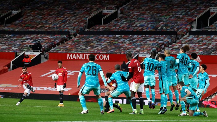 MANCHESTER, ENGLAND - JANUARY 24: Bruno Fernandes of Manchester United celebrates after scoring their sides third goal from a free kick during The Emirates FA Cup Fourth Round match between Manchester United and Liverpool at Old Trafford on January 24, 2021 in Manchester, England. Sporting stadiums around the UK remain under strict restrictions due to the Coronavirus Pandemic as Government social distancing laws prohibit fans inside venues resulting in games being played behind closed doors. (Photo by Martin Rickett - Pool/Getty Images)